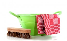 Green metal bucket with cleaning brush
